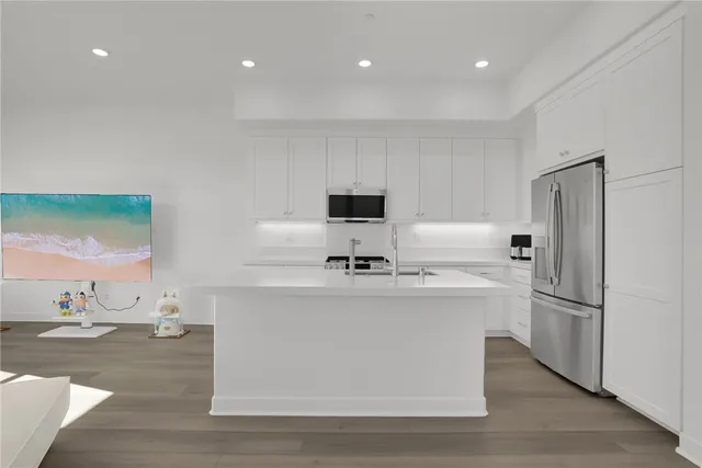 a kitchen with white cabinets and stainless steel appliances