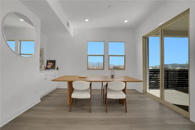 a view of a balcony with floor to ceiling windows and wooden floor