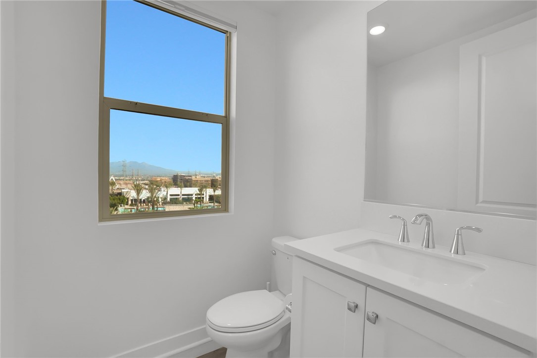 1958 Hollyleaf Terrace Montebello, CA 90640 - Photo 27 of 58 a bathroom with a toilet sink vanity and mirror