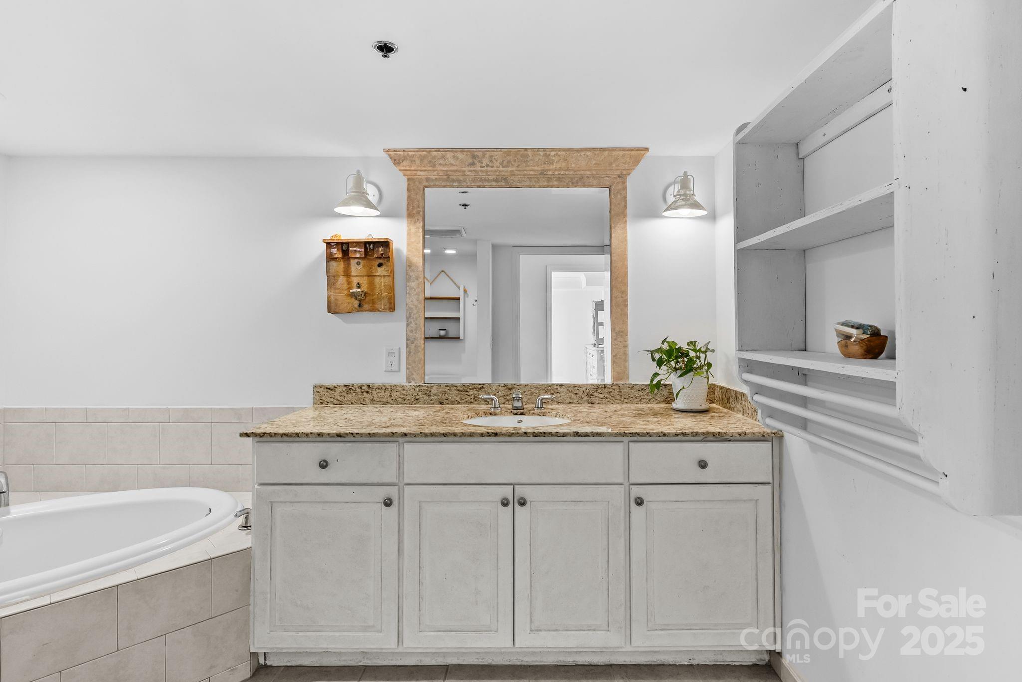 429 Bowling Park Road Asheville, NC 28803 - Photo 20 of 30 a bathroom with a granite countertop sink and a mirror
