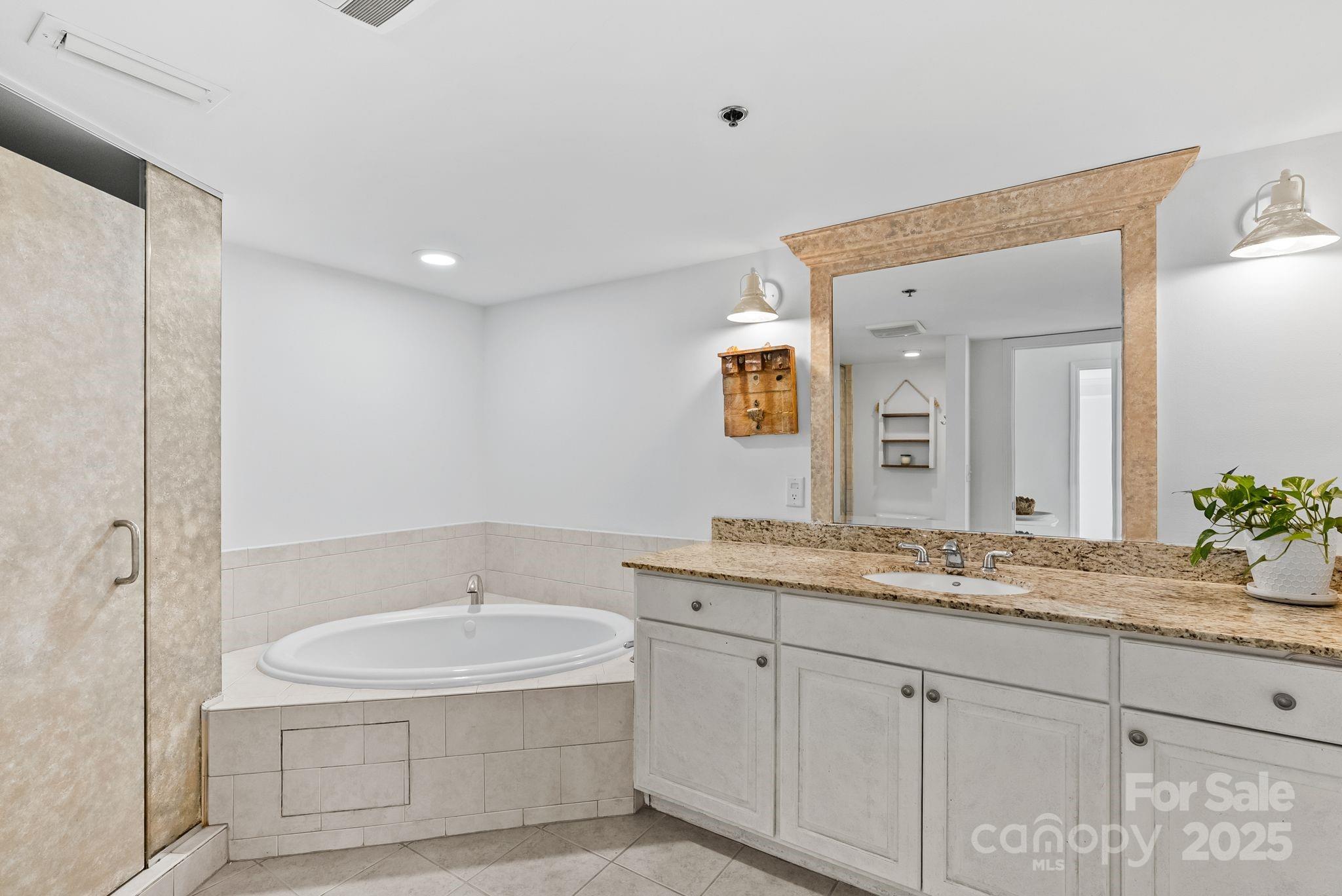 429 Bowling Park Road Asheville, NC 28803 - Photo 21 of 30 a bathroom with a granite countertop sink and a mirror