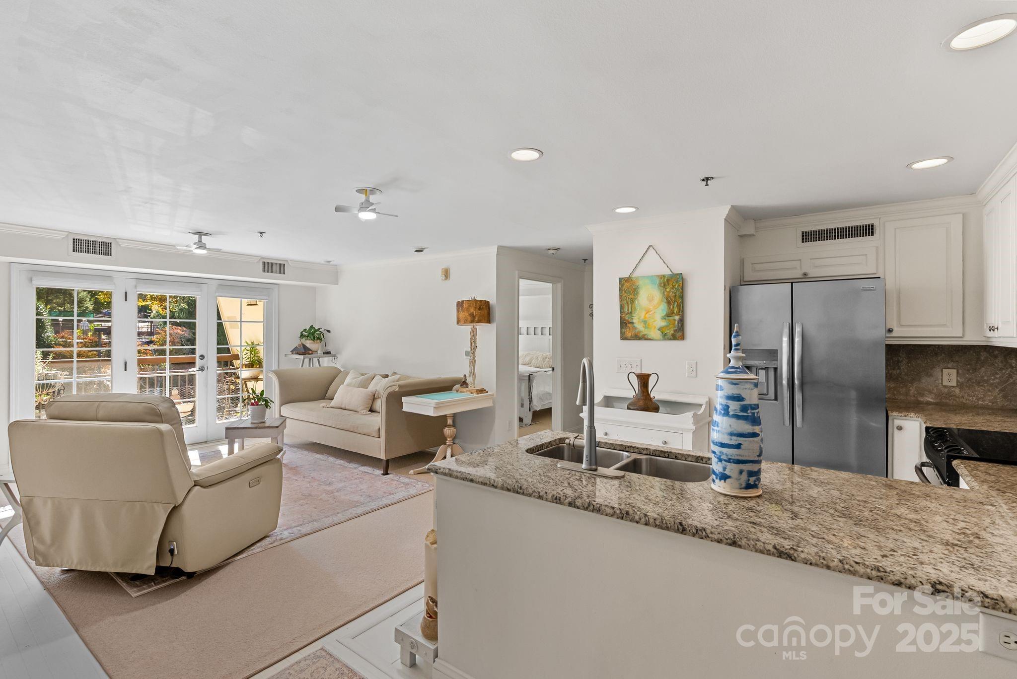 429 Bowling Park Road Asheville, NC 28803 - Photo 4 of 30 a living room with stainless steel appliances granite countertop furniture and a kitchen view