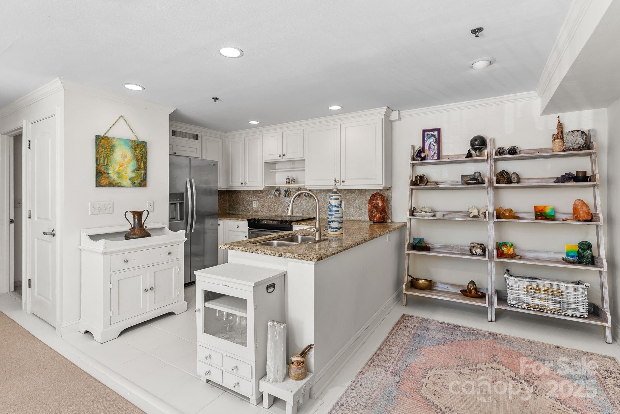 429 Bowling Park Road Asheville, NC 28803 - Photo 7 of 30 a kitchen with stainless steel appliances kitchen island granite countertop a sink and cabinets