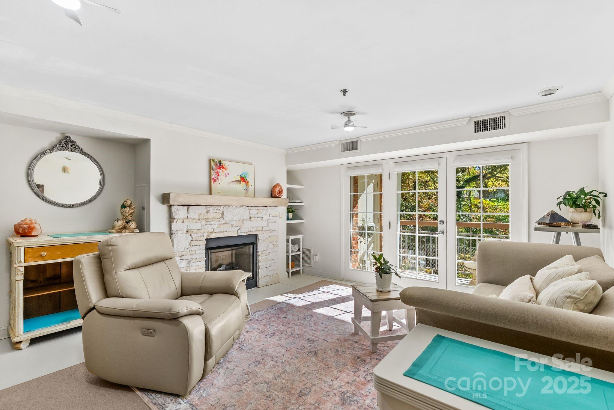 429 Bowling Park Road Asheville, NC 28803 - Photo 10 of 30 a living room with furniture a fireplace and a large window