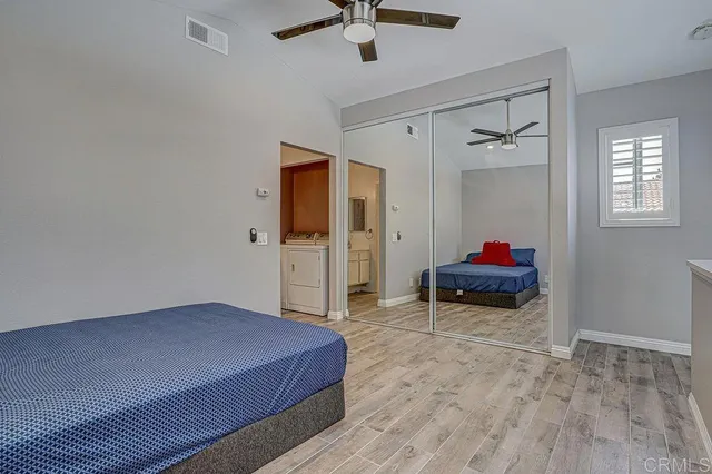 a spacious bathroom with a double vanity sink a mirror and a bathtub