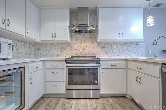 a kitchen with a sink cabinets and stainless steel appliances