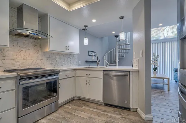 a view of a kitchen with a sink and chandelier