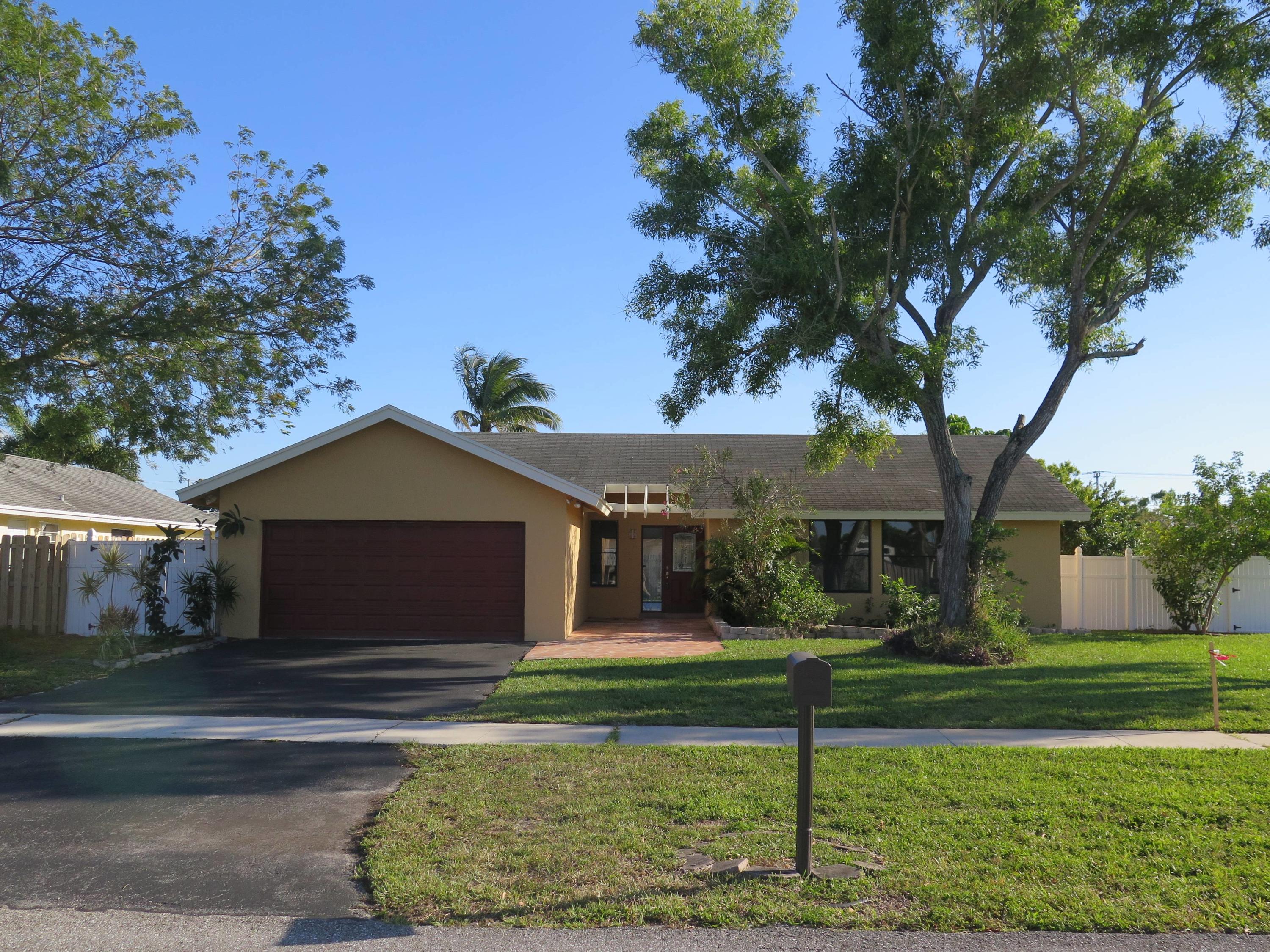 9744 Ohio Place Boca Raton, FL 33434 - Photo 1 of 20 a front view of a house with a yard