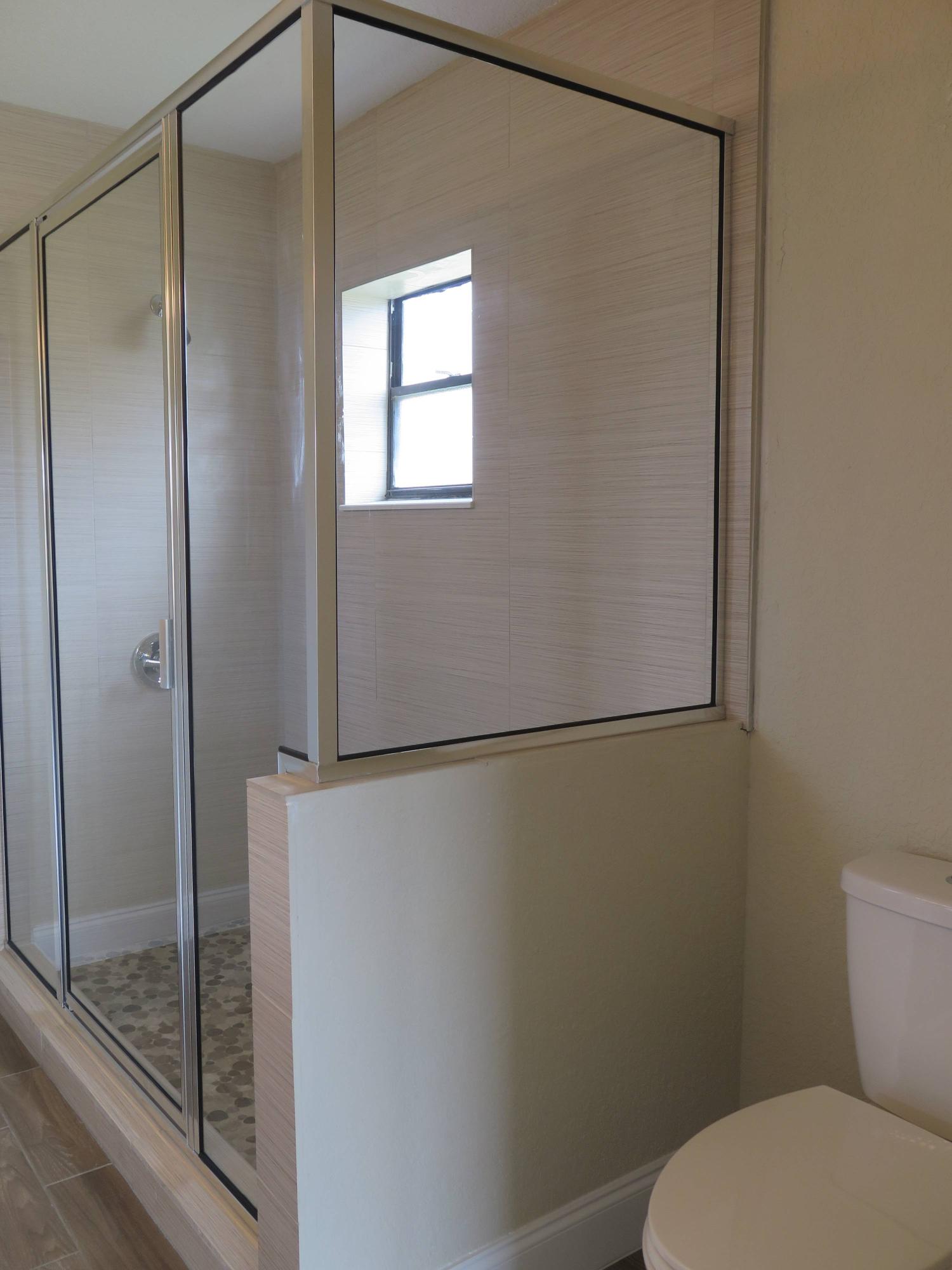 9744 Ohio Place Boca Raton, FL 33434 - Photo 14 of 20 a bathroom with a toilet and a shower