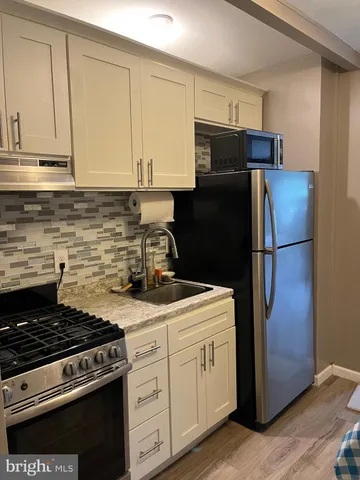 a kitchen with a stove and a refrigerator