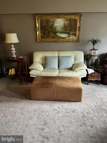 a living room with furniture and a lamp