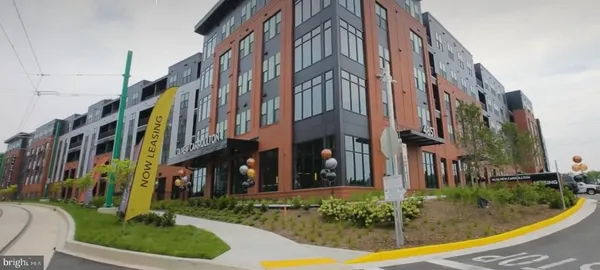 a view of a building with a yard and plants