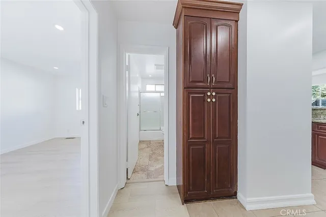 an empty room with closet and mirror