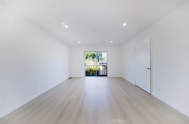 an empty room with window wooden floor and windows
