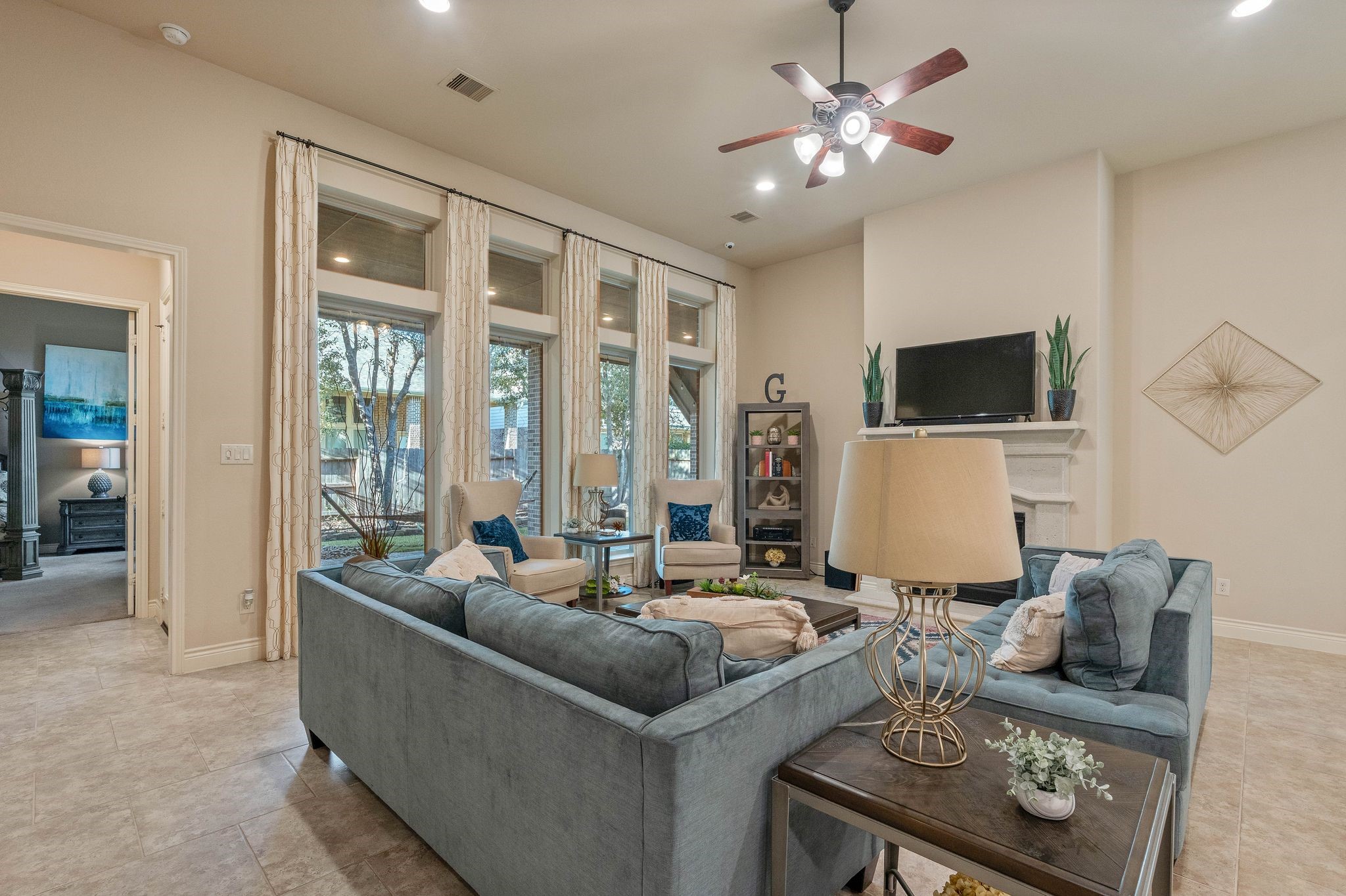 23306 Ridge Spring Drive New Caney, TX 77357 - Photo 16 of 45 a living room with furniture a flat screen tv and a large window