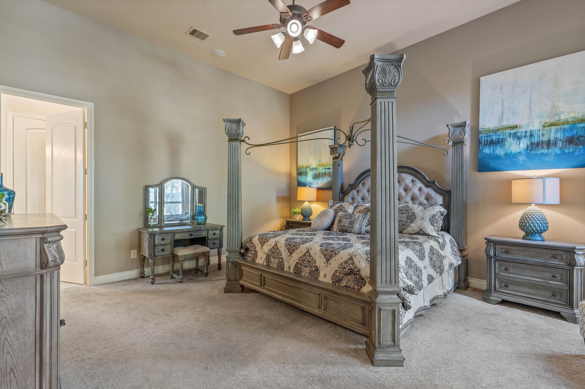 23306 Ridge Spring Drive New Caney, TX 77357 - Photo 24 of 45 a bedroom with a bed and a chandelier