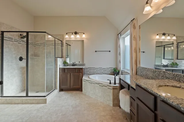 a bedroom with a bed and dresser with chair