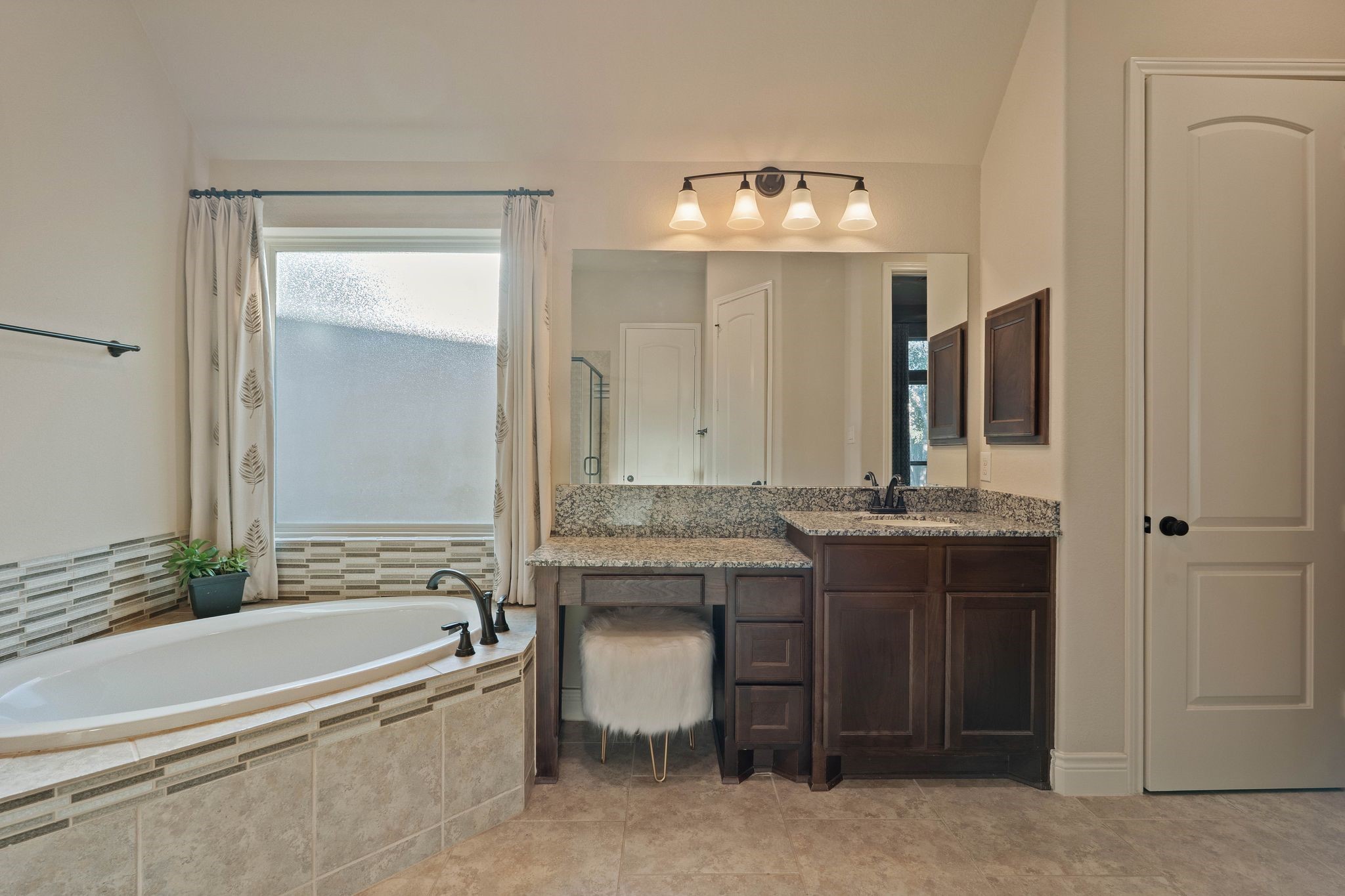 23306 Ridge Spring Drive New Caney, TX 77357 - Photo 27 of 45 a bathroom with a granite countertop sink a toilet and bathtub
