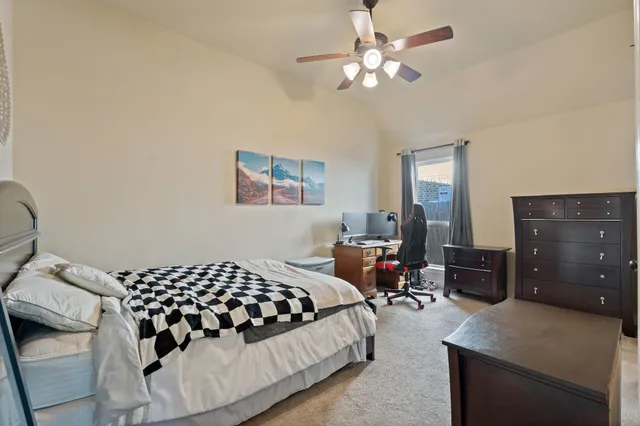a bathroom with a granite countertop sink toilet and shower curtains