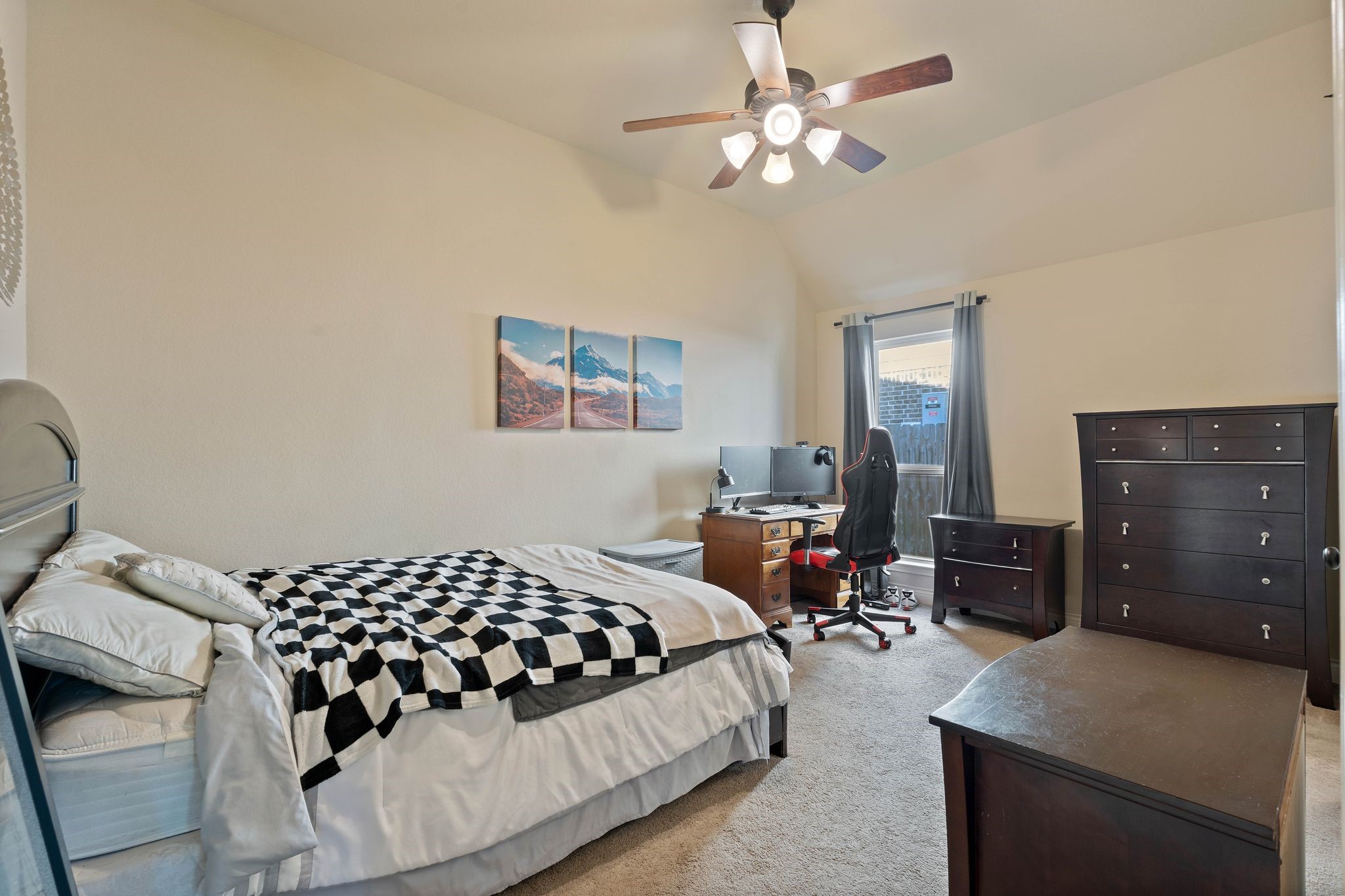 23306 Ridge Spring Drive New Caney, TX 77357 - Photo 29 of 45 a bedroom with a bed and dresser with chair
