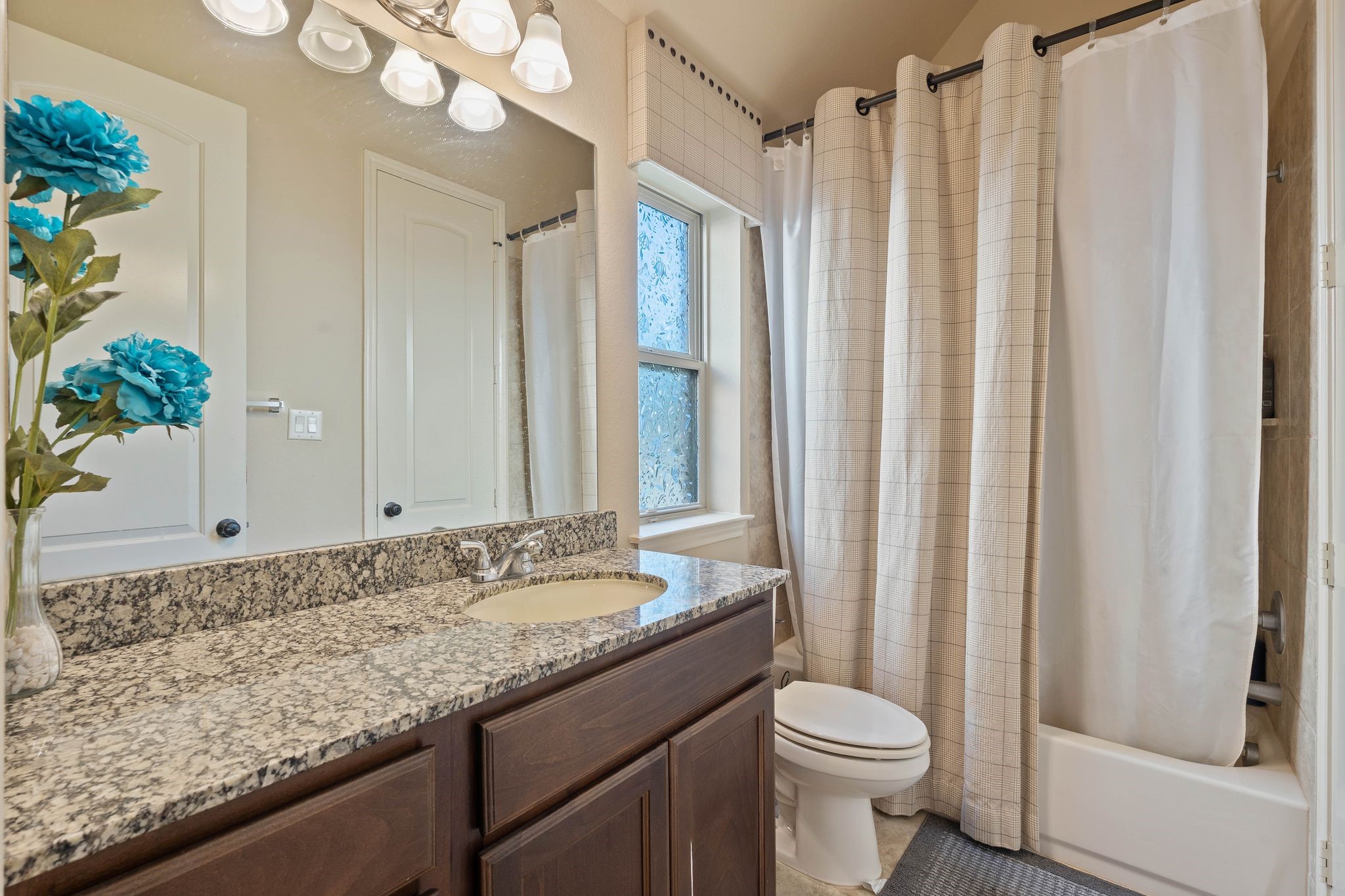 23306 Ridge Spring Drive New Caney, TX 77357 - Photo 30 of 45 a bathroom with a granite countertop sink toilet and shower