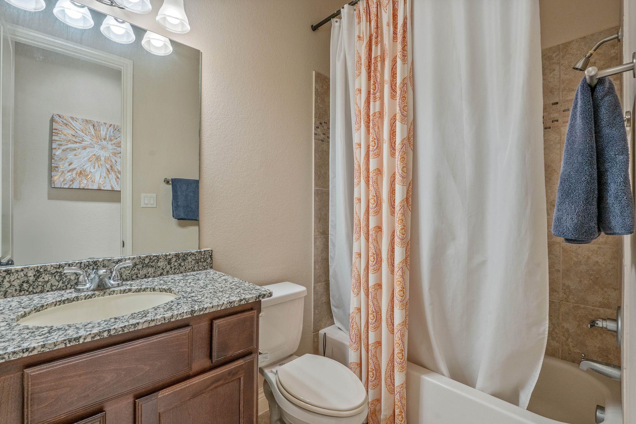 23306 Ridge Spring Drive New Caney, TX 77357 - Photo 33 of 45 a bathroom with a granite countertop sink toilet and shower curtains