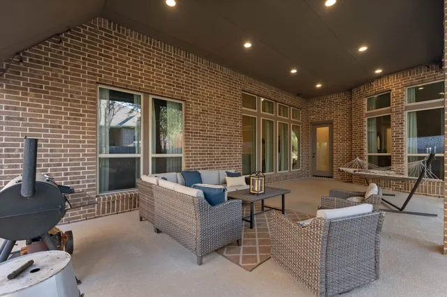 an aerial view of a house with outdoor seating