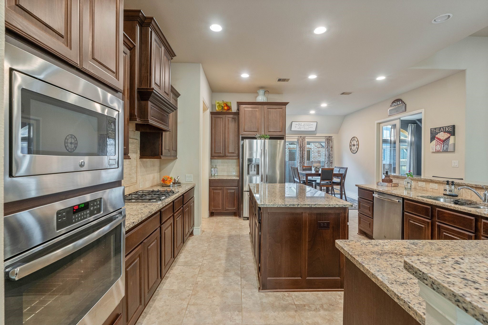 23306 Ridge Spring Drive New Caney, TX 77357 - Photo 7 of 45 a kitchen with stainless steel appliances granite countertop a stove oven and a refrigerator