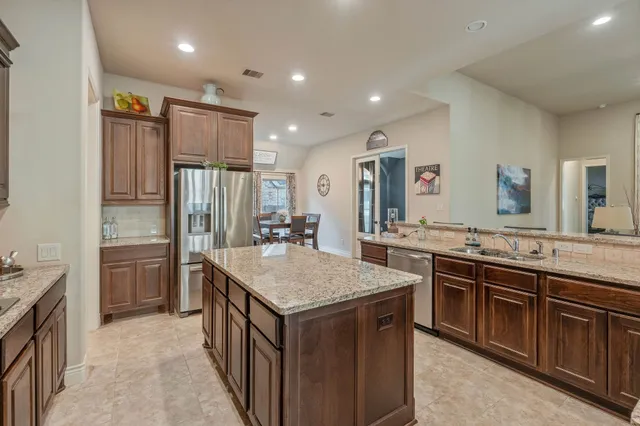 a kitchen with a stove a refrigerator and a sink