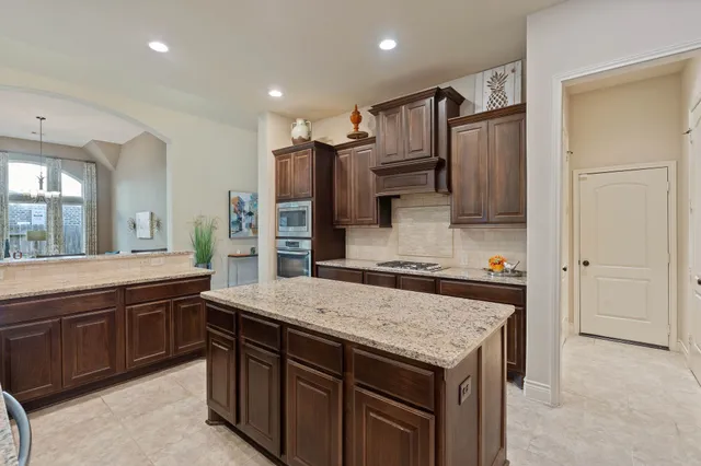 a living room with furniture and a dining table with kitchen view