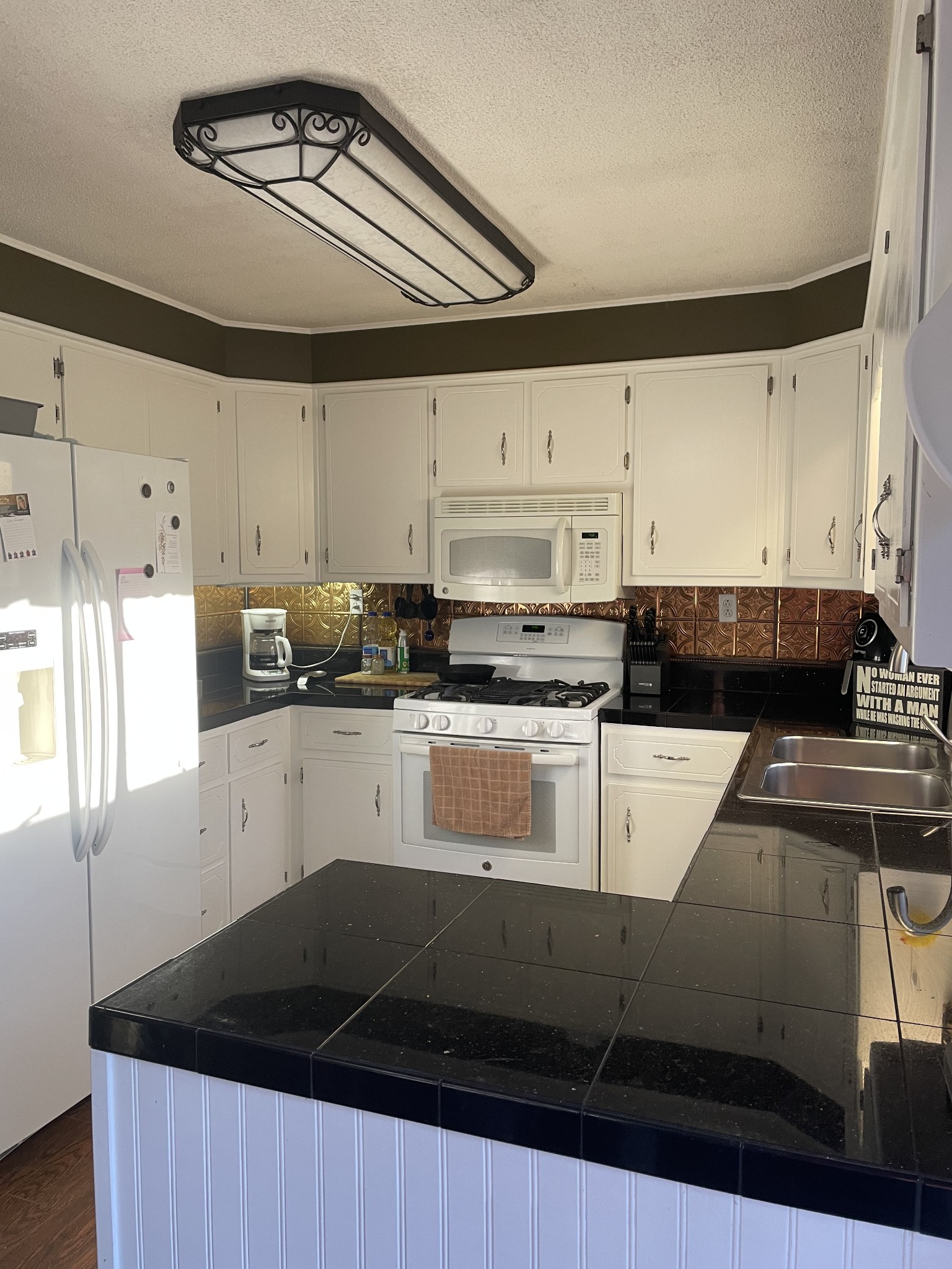 829 Dripping Springs Road Winchester, TN 37398 - Photo 22 of 32 a kitchen with granite countertop a refrigerator a stove and white cabinets