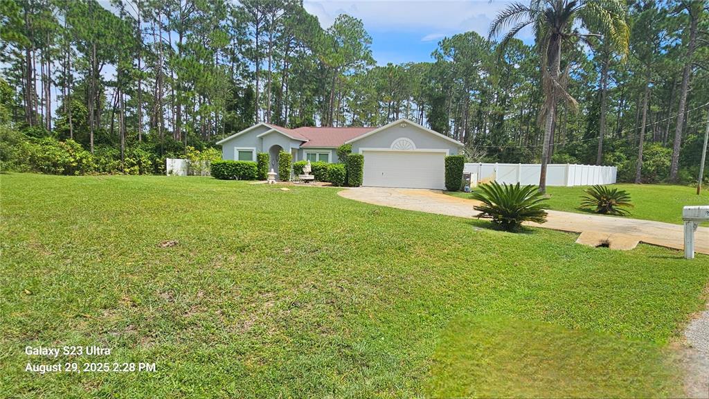 21 Lloleeta Path Palm Coast, FL 32164 - Photo 1 of 17 a front view of a house with garden