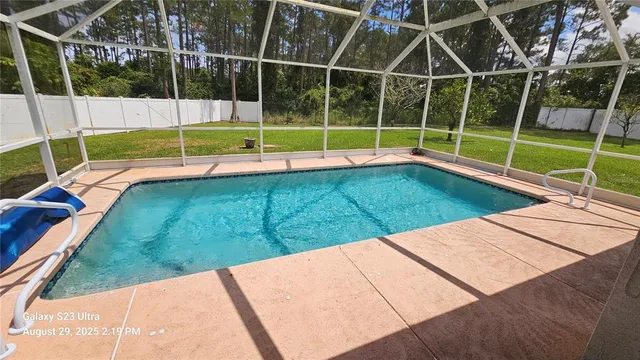 a view of a backyard with swimming pool