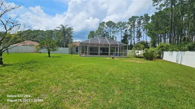 a view of a house with a yard and sitting area