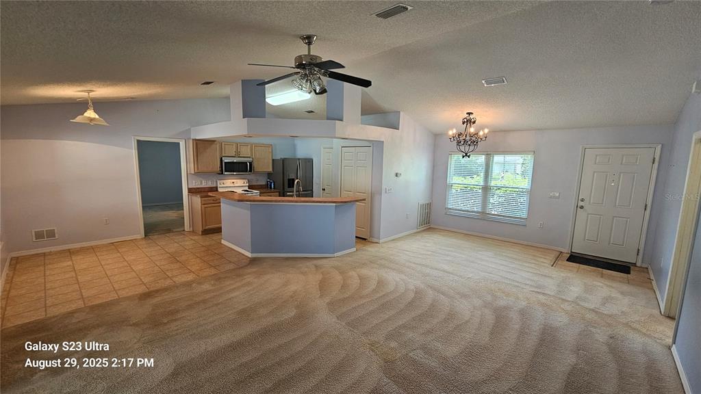 21 Lloleeta Path Palm Coast, FL 32164 - Photo 3 of 17 a view of a kitchen with a sink and a refrigerator