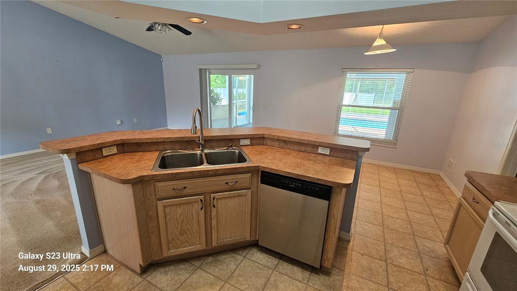 21 Lloleeta Path Palm Coast, FL 32164 - Photo 6 of 17 a kitchen that has a sink and a stove in it