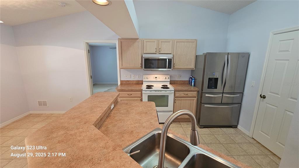 21 Lloleeta Path Palm Coast, FL 32164 - Photo 7 of 17 a kitchen with a refrigerator sink and stove