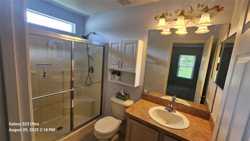 21 Lloleeta Path Palm Coast, FL 32164 - Photo 9 of 17 a bathroom with a sink toilet mirror and shower