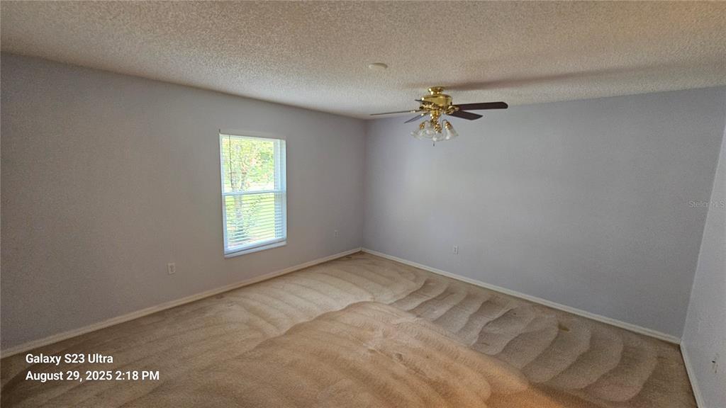 21 Lloleeta Path Palm Coast, FL 32164 - Photo 10 of 17 an empty room with fan and windows