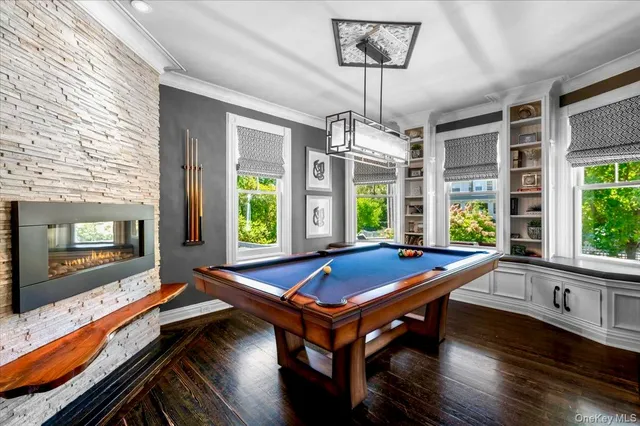 a room with pool table and windows