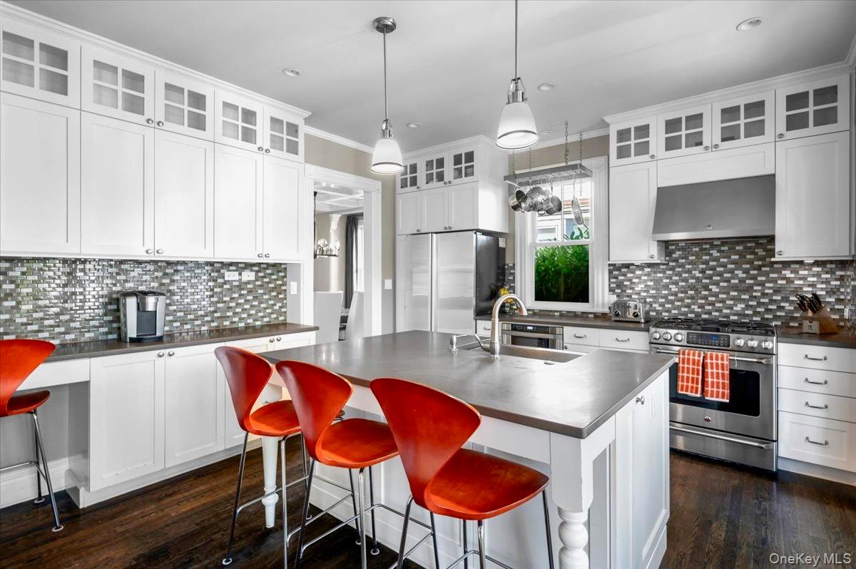 201 North Broadway Nyack, NY 10960 - Photo 13 of 36 a kitchen with stainless steel appliances granite countertop a sink a stove a refrigerator a dining table and chairs with wooden floor
