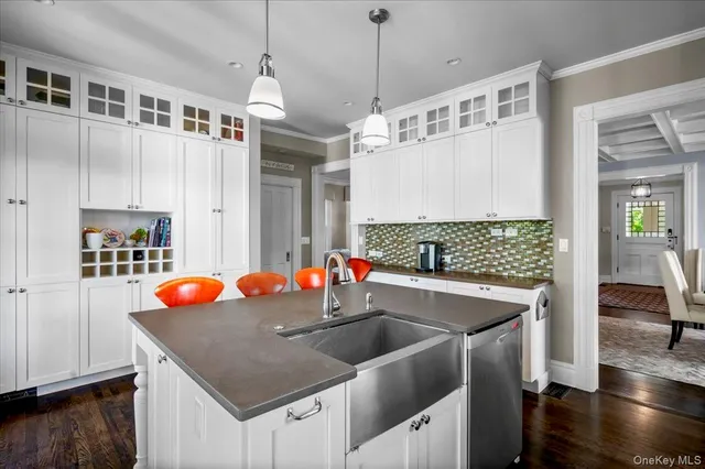 a kitchen with stainless steel appliances granite countertop a sink and a white cabinets