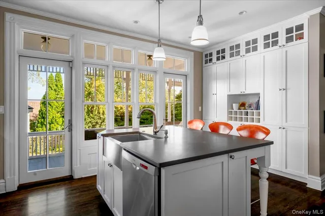 a open kitchen with stainless steel appliances granite countertop a sink and wooden floor