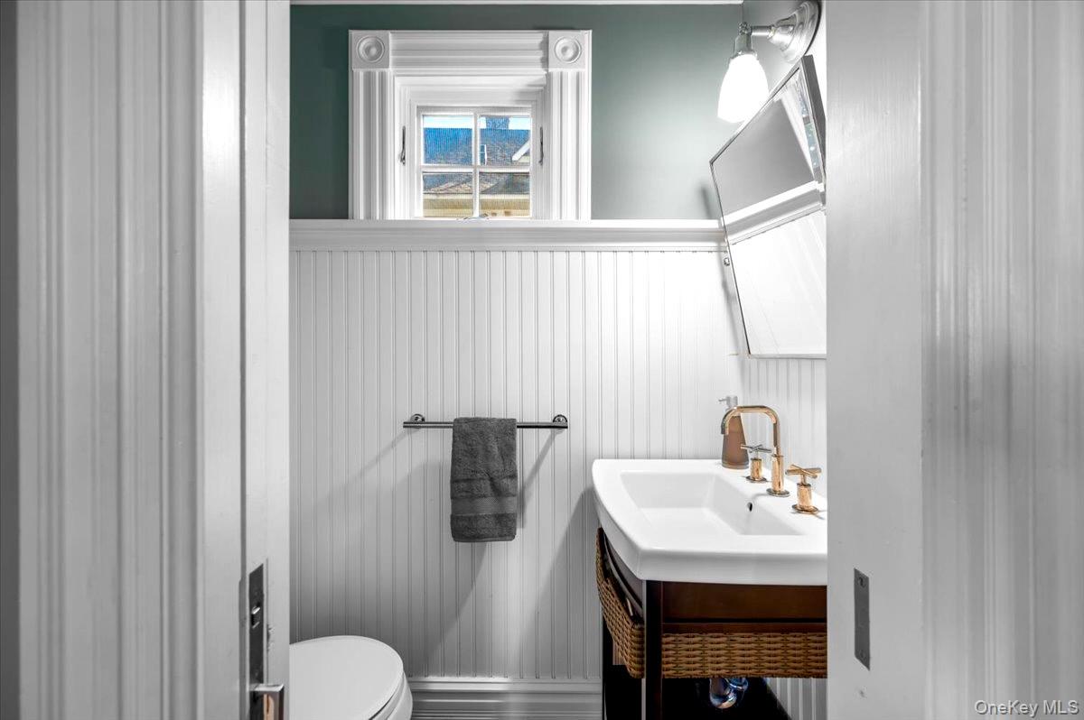201 North Broadway Nyack, NY 10960 - Photo 17 of 36 a bathroom with a sink a toilet and mirror