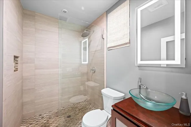a bathroom with a granite countertop toilet sink and shower