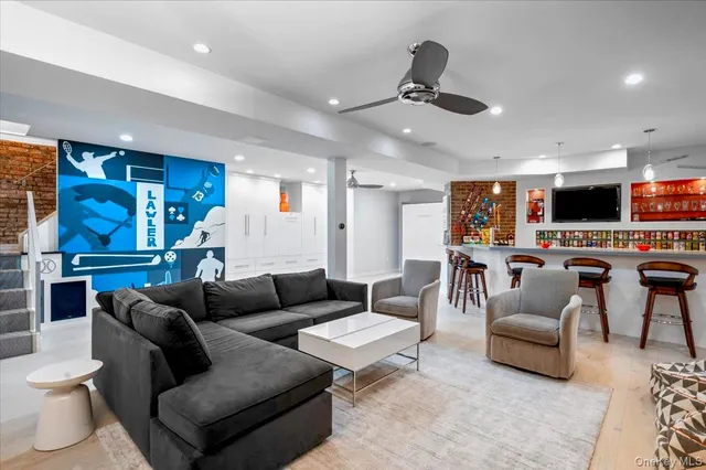 a living room with furniture and a ceiling fan