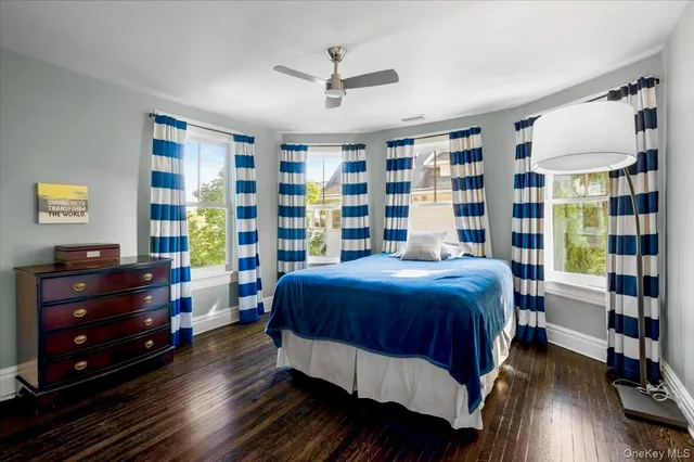 a spacious bedroom with a bed and a chandelier