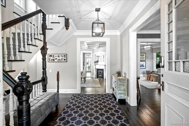 a view of entryway and hall with wooden floor