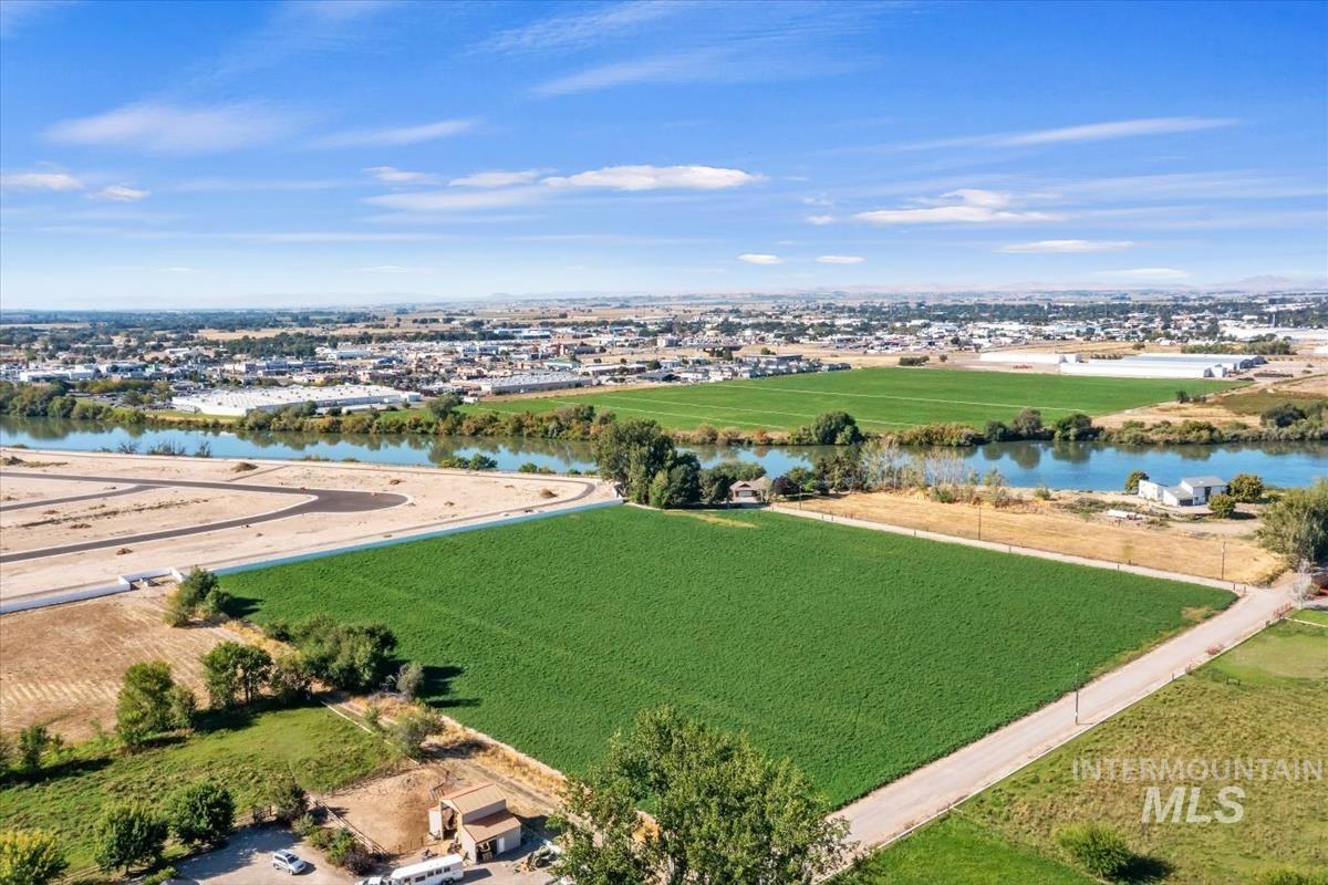 8275 Washoe Road Fruitland, ID 83619 - Photo 39 of 43 Expansive land parcel featuring green fields, a river, and distant cityscape