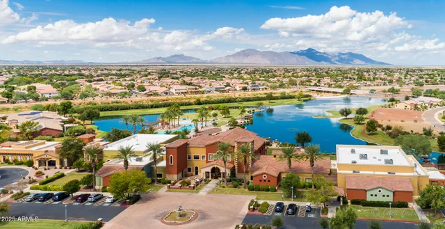 a living room with a table chairs and a dining table with wooden floor